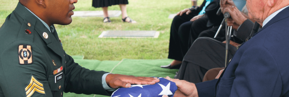 military servicemen giving flag to family