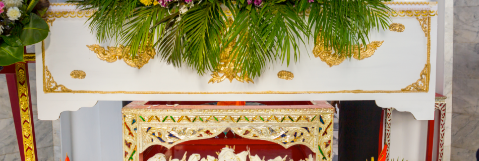 A Buddhist funeral white casket with flower arrangement
